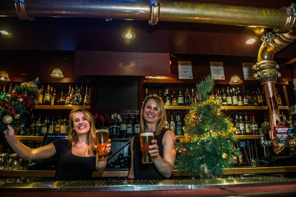 16 bar staff, inculding Lydia and Emma, will be on hand on Christmas eve to keep punters well watered. Photo: Karleen Minney