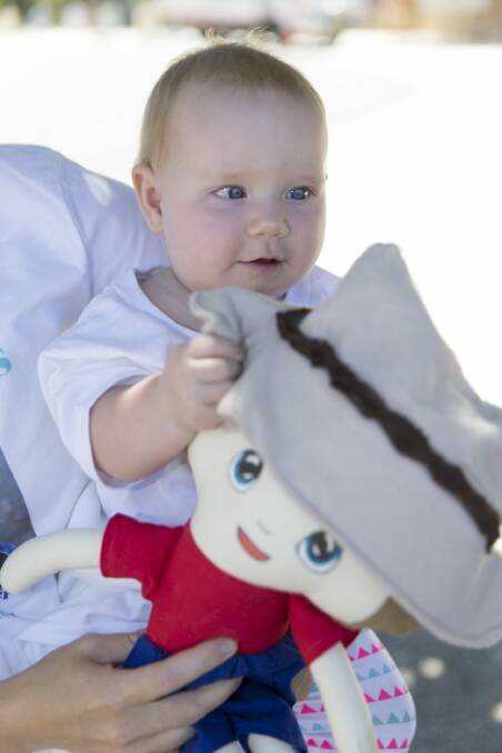 Eight-month-old Grace Finley holding her "Bill'' doll made for her in memory of her uncle Bill Spencer. Photo: Ray Vance