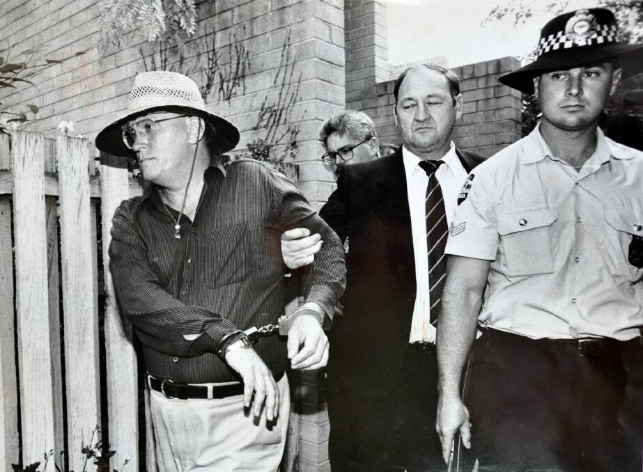 David Harold Eastman is arrested and handcuffed and is led to a police vehicle in December 1992,  in relation to the assassination of AFP Assistant Commissioner Colin Winchester. Photo: Graham Tidy