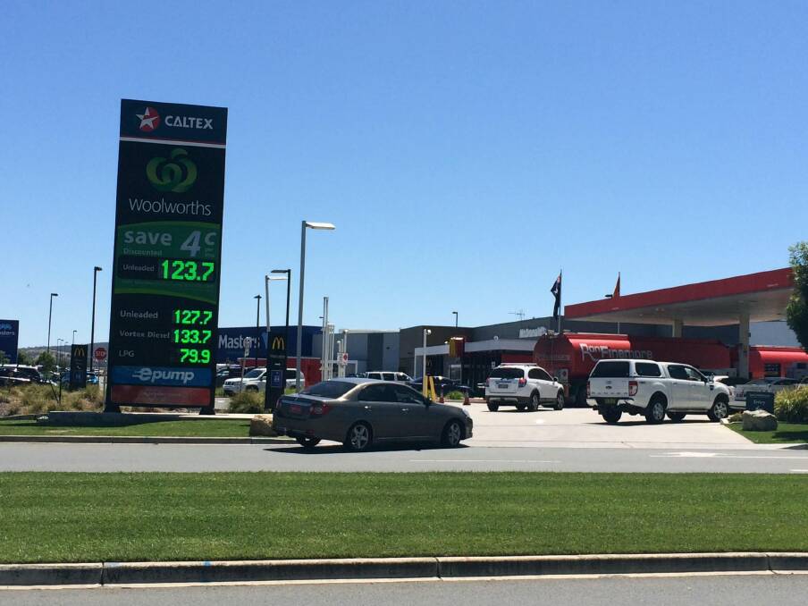 The electronic advertising sign outside the service station on Monday morning showing unleaded petrol at 123.7 cents per litre for customers with a discount, the same price as the supermarket chain’s rival Costco. Photo: Clare Colley