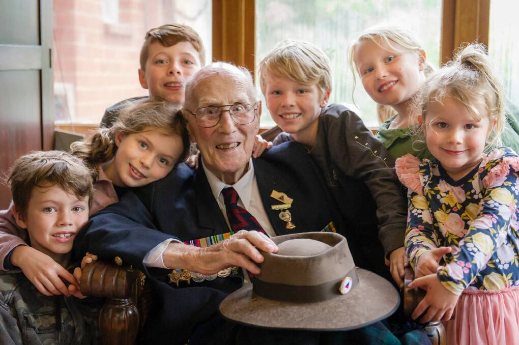 WWII veteran John Hendry surrounded by great-grandchildren after participating in the 2017 Anzac Day National Ceremony. Photo: Sitthixay Ditthavong