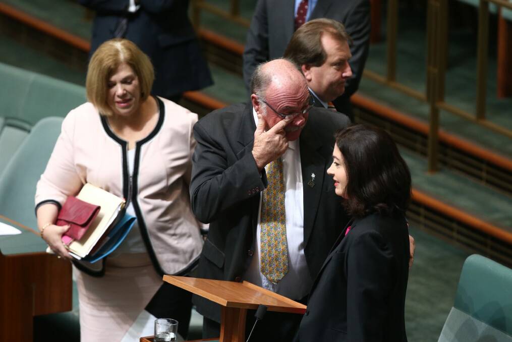 Warren Entsch wipes a tear away with Labor MP Terri Butler. Photo: Andrew Meares