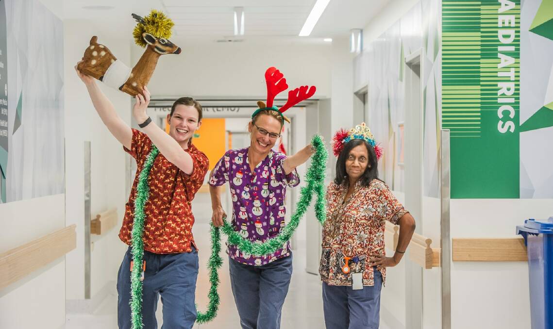 Canberra hospital nurses working over the Christas period sporting Christmas themed scrubs. (from left) Tennille Rayner, Kellie Huey and Rahini Beaumont. Photo: Karleen Minney