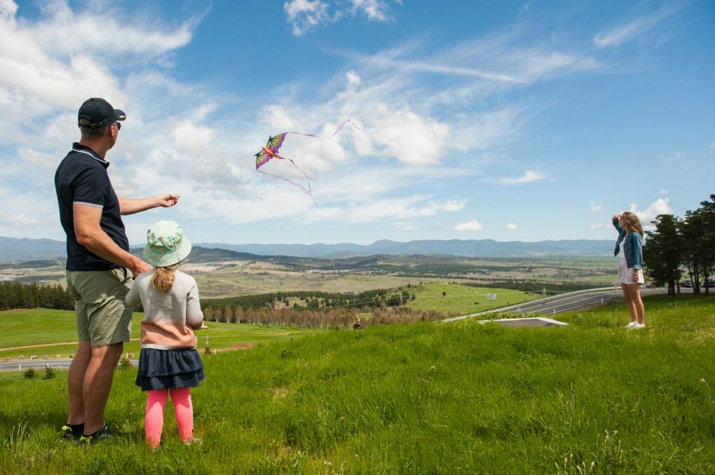 Justin Smith, Selita Canton-Smith, 3, and Isabella Smith, 15 fly a kite at the National Arboretum Forest open day. Photo: Elesa Kurtz