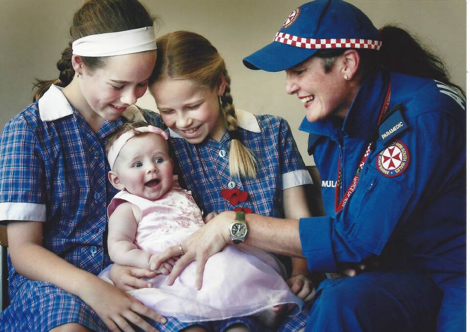 In 2008 - Laura, 12, Caitlin, 10, with baby Ella Bishop, 19 weeks, and Albury paramedic Fiona Dillon. Photo: Kylie Goldsmith