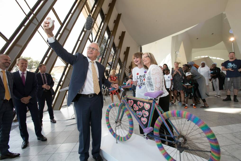Prime Minister Malcolm Turnbull takes a selfie with the bike, its artist Eloise Murphy and his wife Lucy at the National Museum of Australia on Thursday. Photo: NATIONAL MUSEUM OF AUSTRALIA