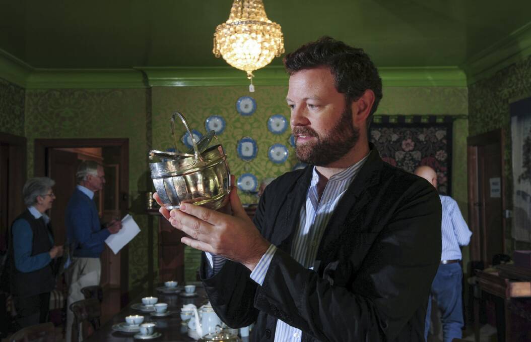 Robert Williams inspects a rare George III double-lidded sterling silver tea caddy, which is among items at Huntly to be sold at auction. Photo: Graham Tidy