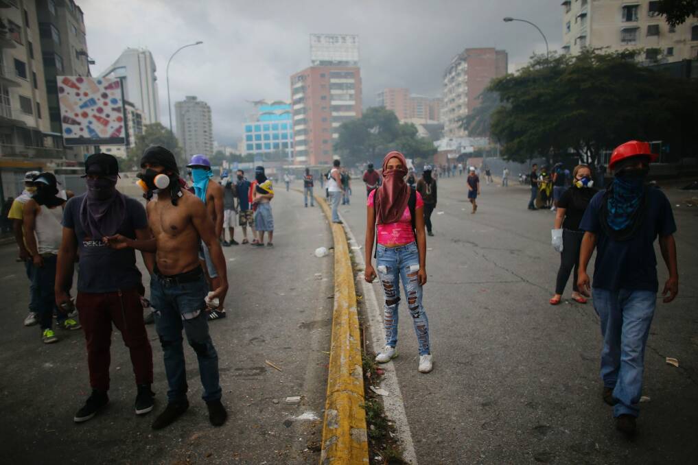 Anti-government demonstrators block a street during clashes with National Guards in Caracas, Venezuela. Photo: AP