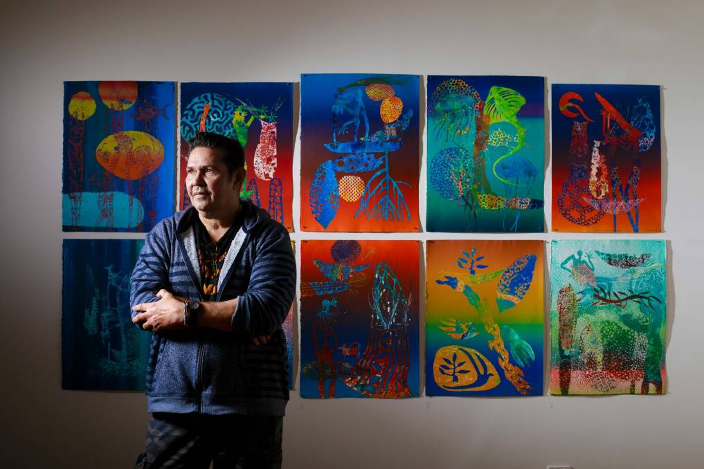 Artist Arone Meeks with some of his prints at Megalo Print Gallery + Studio.  Photo: Sitthixay Ditthavong