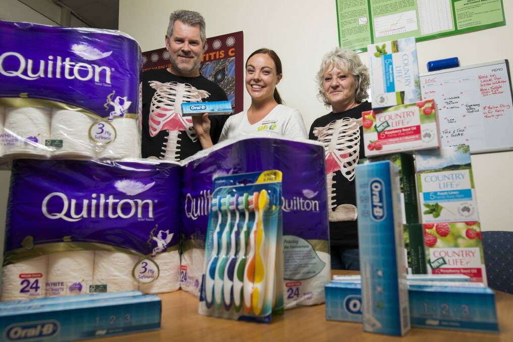 Hepatitis ACT executive officer John Didlick, GIVIT media manager Kayla Brereton and community educator Kerrie McKenzie with the donated items.  Photo: Rohan Thomson