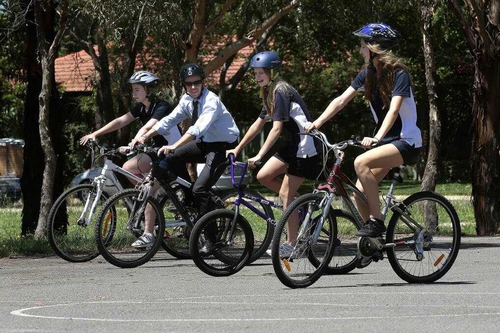 Road Safety Minister Shane Rattenbury rides with students at University of Canberra High School in Kaleen. Photo: Jeffrey Chan.