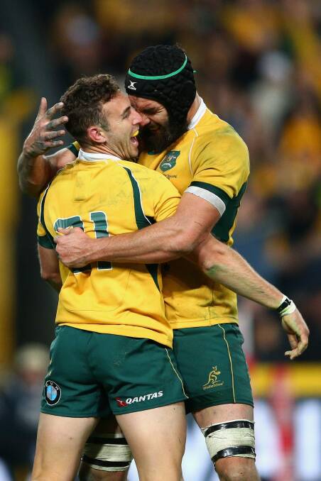 Time for celebration: Nic White is hugged by teammate Scott Fardy. Photo: Cameron Spencer