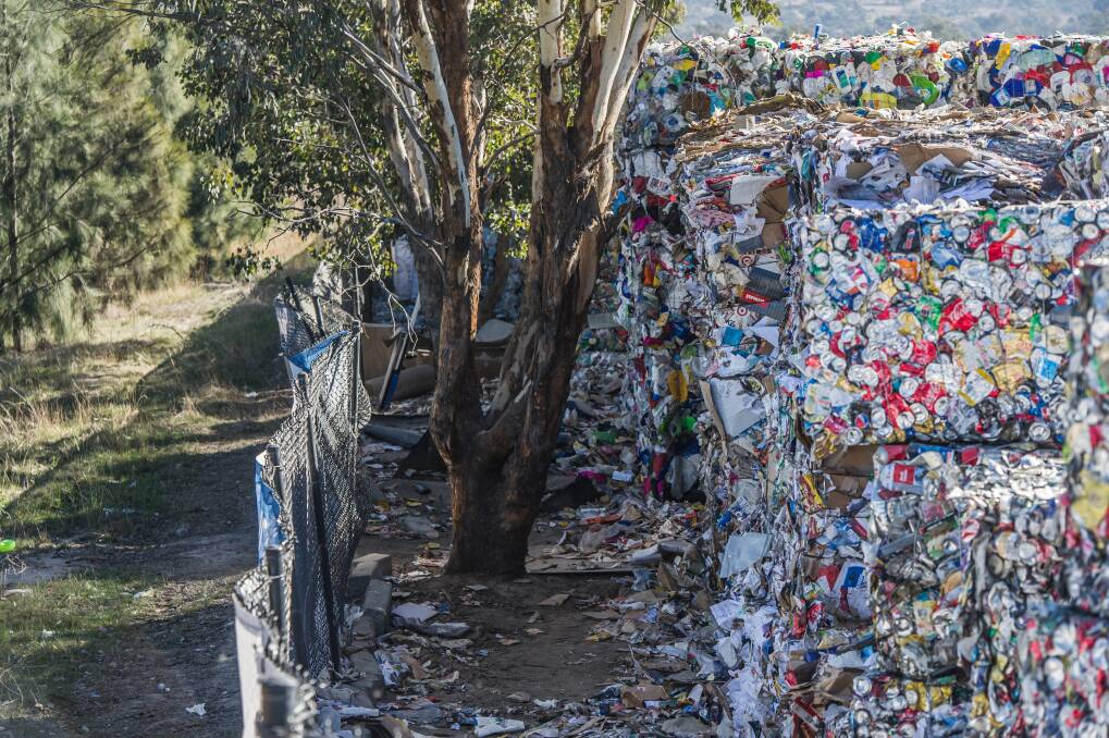 The bales of recycled waste at the ACT Materials Recovery Facility are piled up higher than the fences. Photo: Karleen Minney