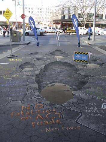 A chalk drawing, above, by artist Rudy Kistler to draw attention to road maintenance issues. Photo: David Ellery