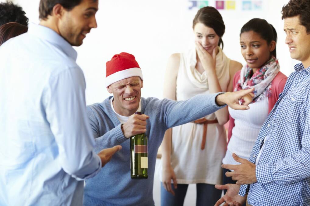 A male employee having too much fun at the office party while his colleagues look on  Christmas party, office christmas party, generic, istock Photo: Supplied