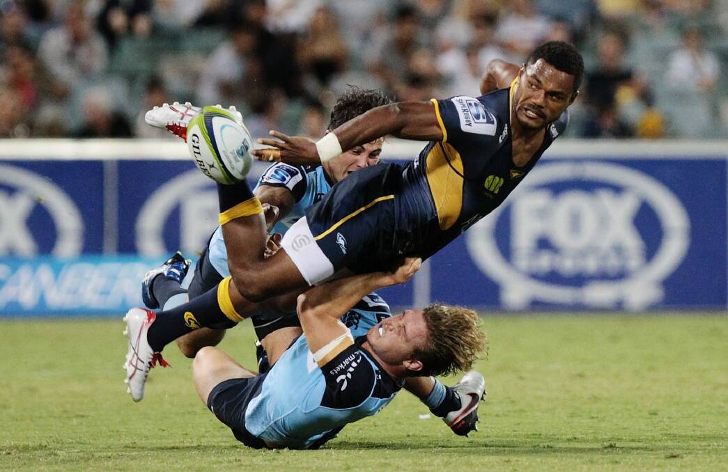 Tough battle: Henry Speight of the Brumbies gets the ball away against the Waratahs. Photo: Getty Images