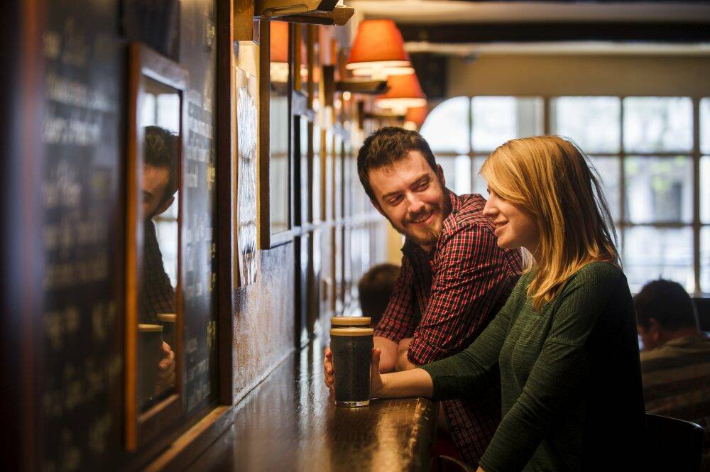 Andrew Deakins and Anna Trundle from Turner enjoy a Stout at the Wig and Pen on Sunday. Photo: Rohan Thomson