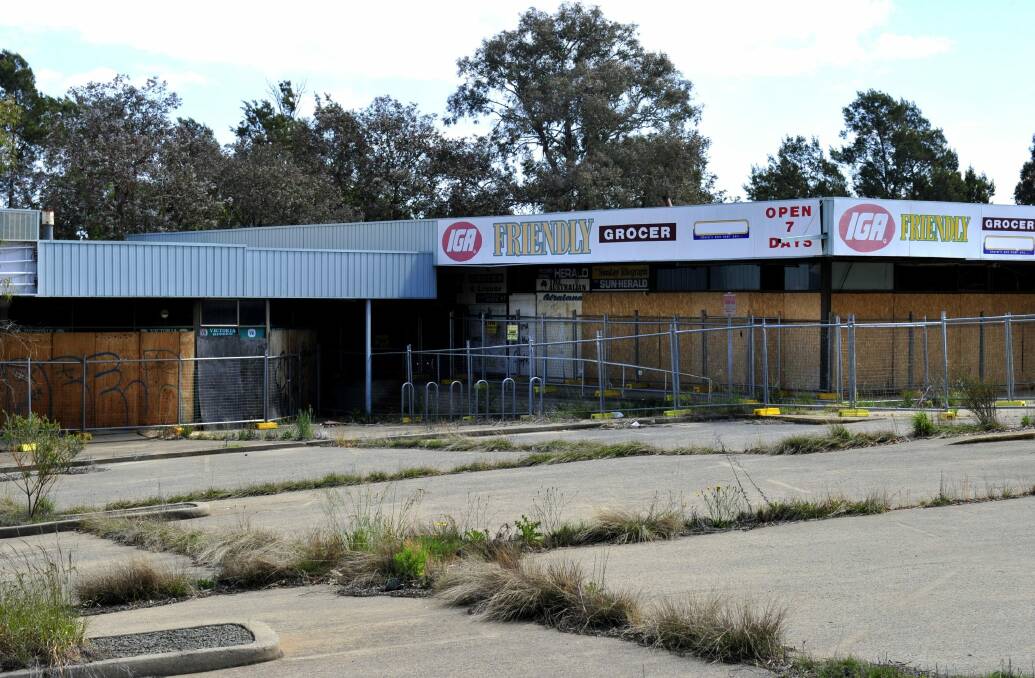 The site of the Giralang's once bustling local centre, as pictured in 2013, which began a slow decline years before the remaining supermarket closed in 2004. Photo: Melissa Adams