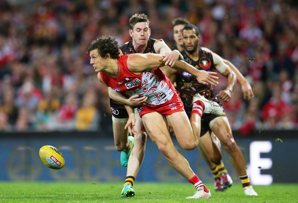 Reined in: Kurt Tippett is tackled during Hawthorn's last minute win over the Swans, who almost staged a comeback at the SCG. Photo: Matt King