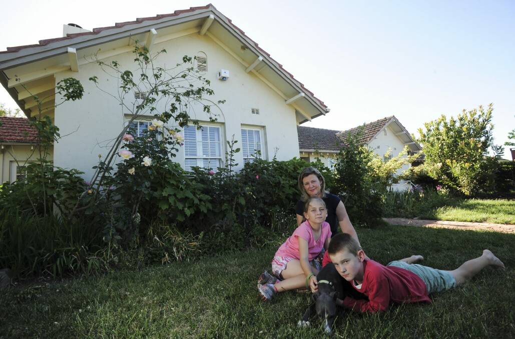 ‘NO ONE CAN SAVE IT NOW’: Fluffy homeowner Karen with her children Scarlett, 10 and Daniel, 12, and the family dog Gary outside their heritage-listed home. Photo: Graham Tidy