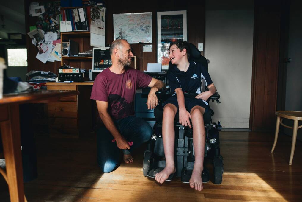 12-year-old Lily Sharrock, who has cerebral palsy, with her father Jim. Photo: Rohan Thomson