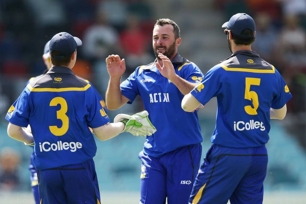 Mick Delaney of ACT celebrates with teammates after taking the wicket of Dogodo Bau. Photo: Getty Images