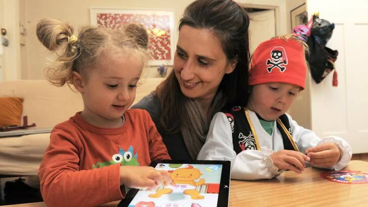 "Big Baby" App designer, Gabrielle Banks, at her Barton home with her two children Max Horth, 4 and Nelly Horth, 3, playing the game on their iPad. Photo: Graham Tidy