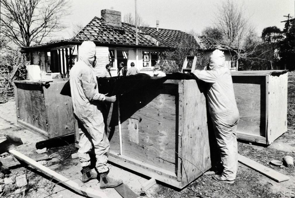 GUTTED: Workers remove asbestos from a home during a remediation project in O’Connor in 1987.