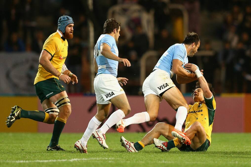 Down and out: Matt Toomua, right, cops a heavy bump during the Wallabies' match against Argentina. Photo: Getty-Images
