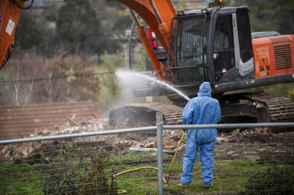 Workers demolish a Mr Fluffy home in Woden valley.  Photo: Rohan Thomson