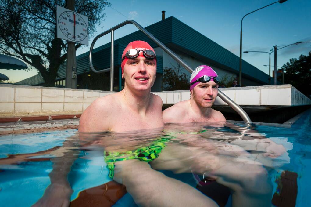 Ben Freeman and Joe Pascall in the chilly waters of the unheated Phillip pool. It was down to 14 degrees in the water one Friday in early June. Photo: Dion Georgopoulos