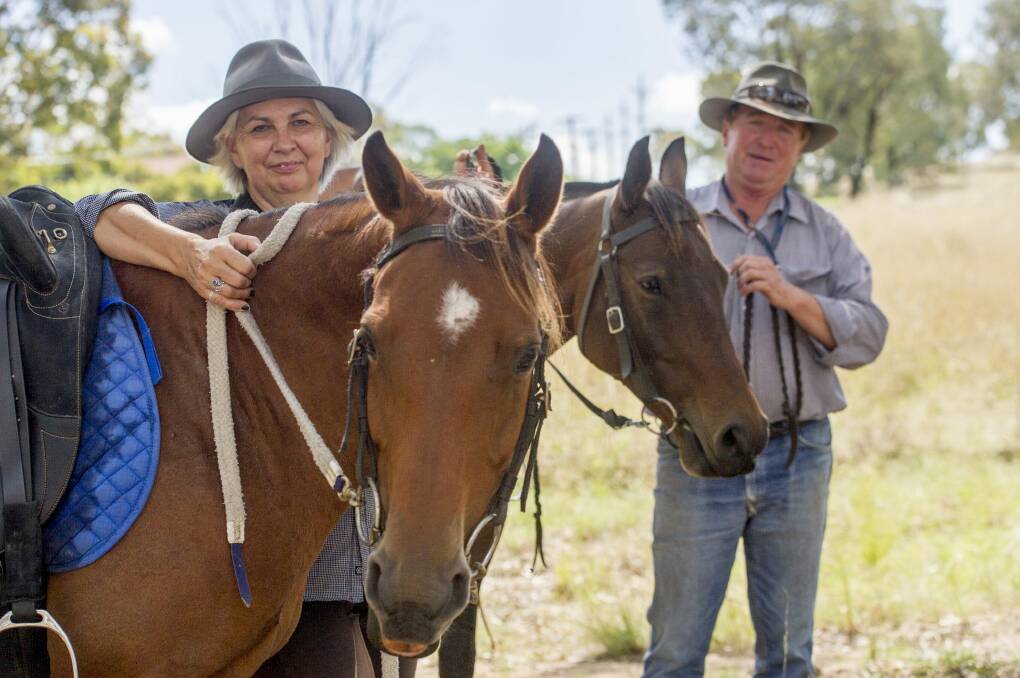 Robert Brice and his partner Judi Lopez, with horses Charlie and Precision, at Kambah. Photo: Jay Cronan