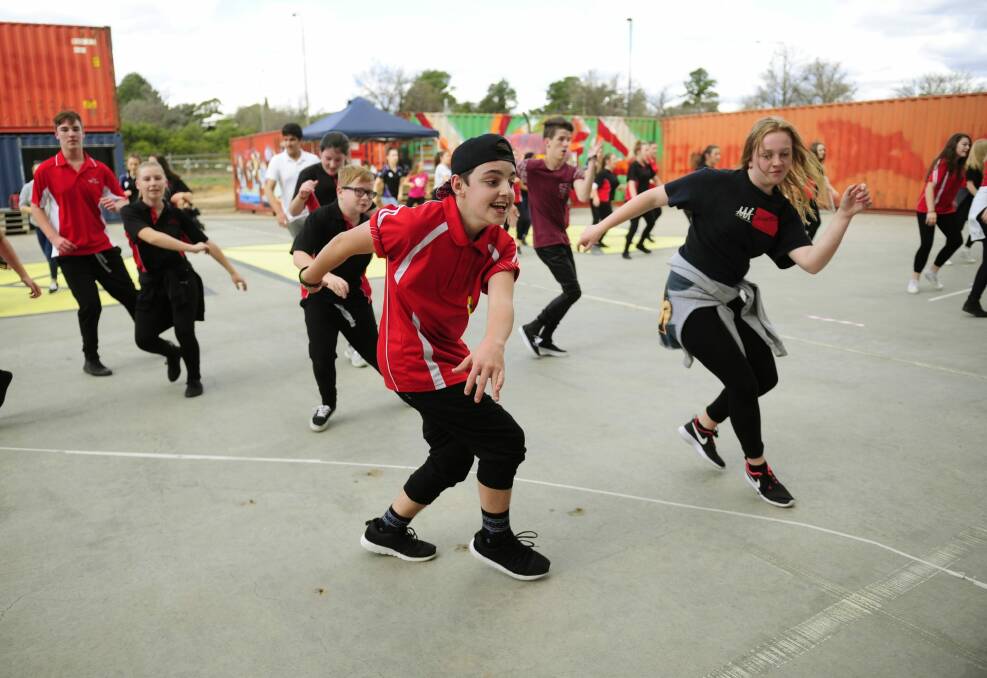 From left, Calwell High school year 10 students, Jacob Brown, 15, of Gilmore and Grace Forbes, 15, of Jerrabomberra take part in the outdoor dance jam held at the Westside Acton Park for the launch of Ausdance ACT Australian dance week in Canberra. Photo: Melissa Adams