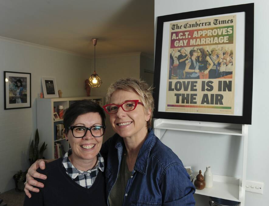 Julie Maynard, left, and Frankie Bodel at their home in Belconnen. They featured on the front page of The Canberra Times almost three years ago, kissing in the public gallery of the ACT Legislative Assembly when laws allowing same-sex marriage were passed. Photo: Graham Tidy