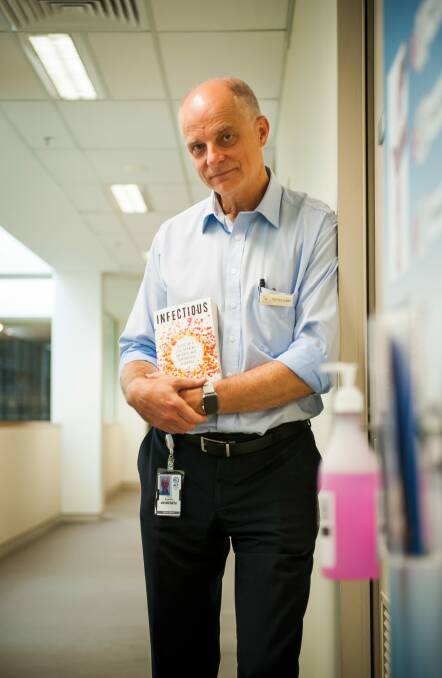 Professor Frank Bowden with his book Infectious. Photo: Elesa Kurtz