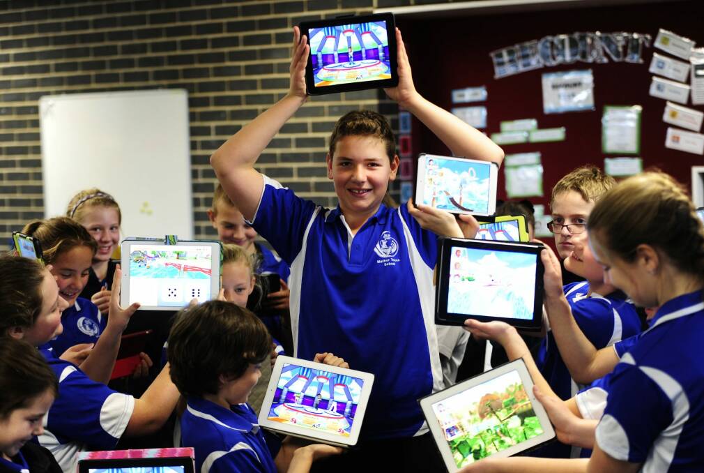 Children in class 6 Ebony led the charge as Mother Teresa Catholic Primary School in Harrison became the first school in the ACT to answer one million questions using Skoolbo. Joshua Drennan,11, celebrated with classmates on Wednesday. Photo: Melissa Adams 