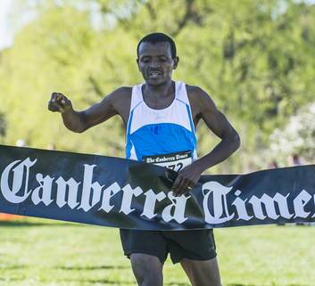 First male finisher Gemechu Woyecha crosses the line in 30 minutes 30 seconds. Photo: Rohan Thomson