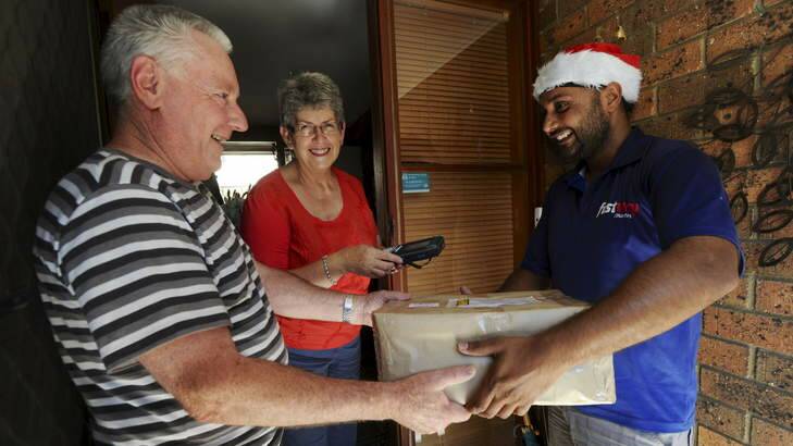 Courier driver, Mandip Singh, makes a final delivery for the day, at a home in Isaacs to Richard and Lois Cooper. Photo: Graham Tidy