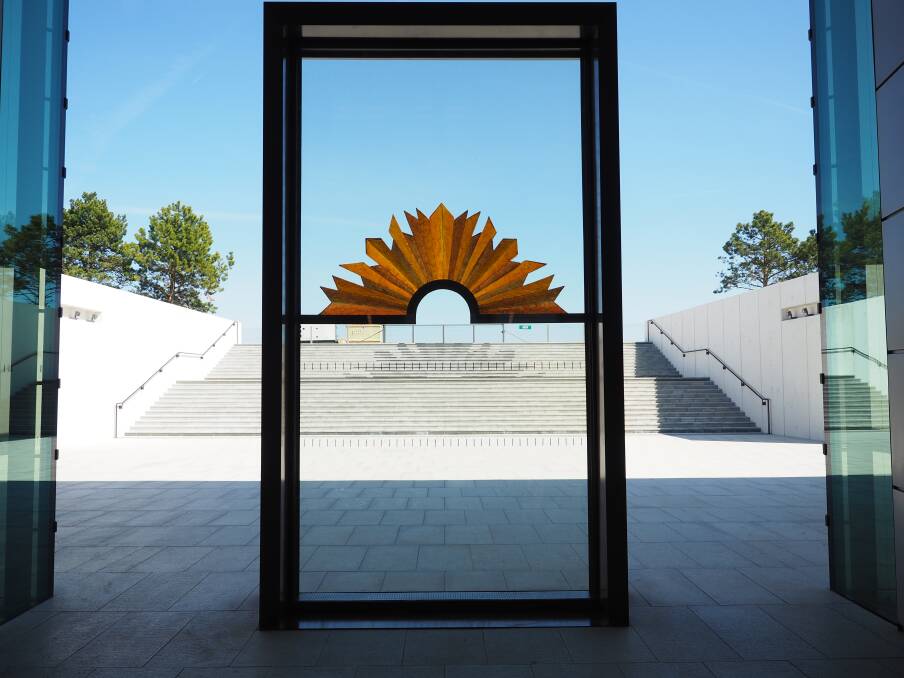 The rising sun sculpture at the new World War One memorial in France. Canberra sculptor Dan Lorrimer made the supporting bar and Lisa Cahill created the glassworks.