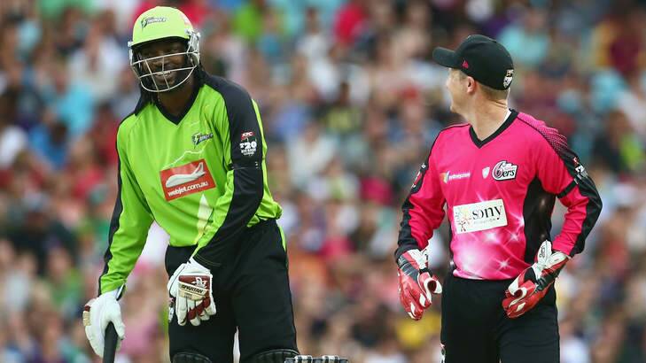 Chris Gayle of the Thunder and Brad Haddin of the Sixers share a laugh during a Big Bash match. Photo: Mark Kolbe