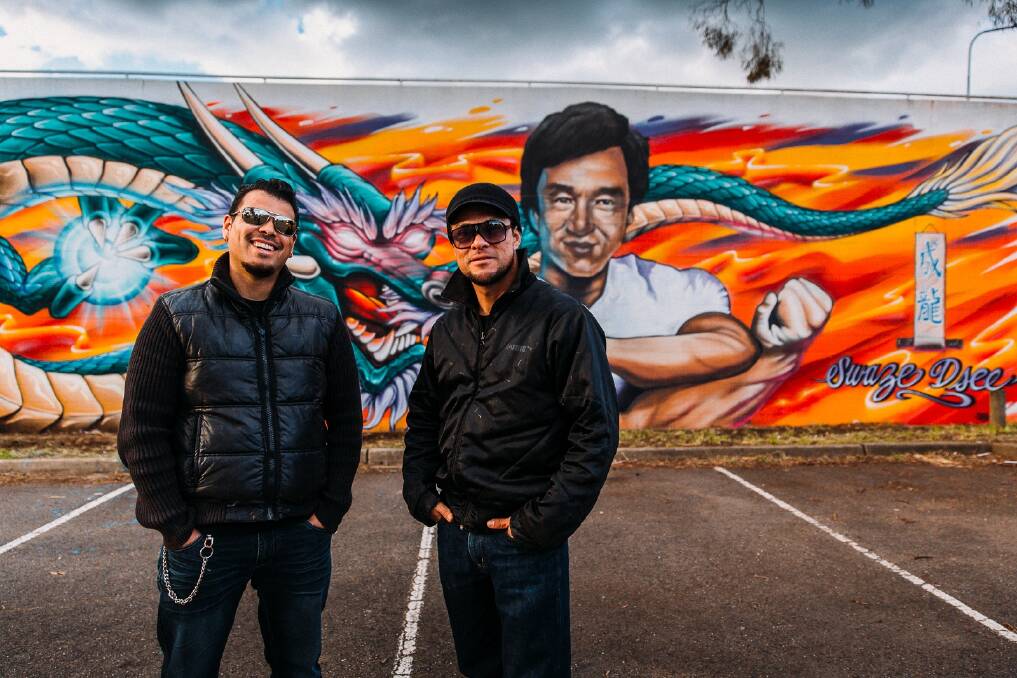 Artists David Chavez aka DSEE and Ian Ballesteros aka Swaze with their completed mural of Jackie Chan in Dickson. Photo: David Beach