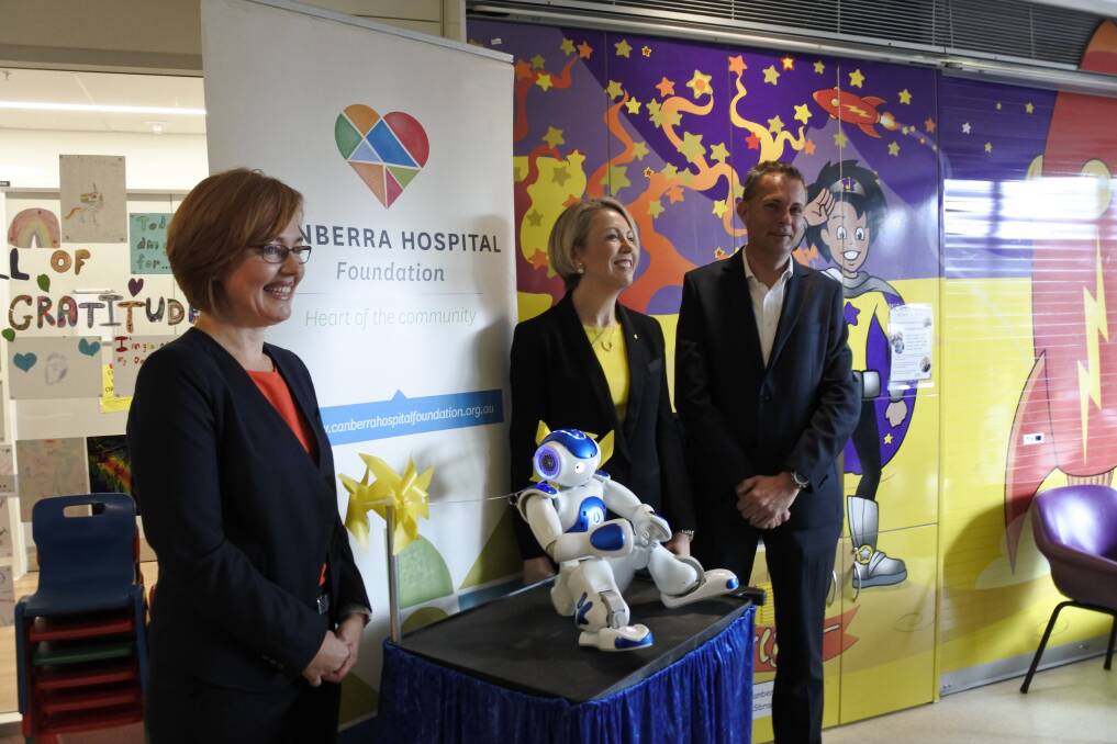 Health Minister Meegan Fitzharris, Canberra Hospital Foundation chair Debbie Rolfe and foundation board member James Willson at the unveiling on Friday of the new $25,000 robot at the Centenary Hospital for Women and Children. Photo: Megan Doherty