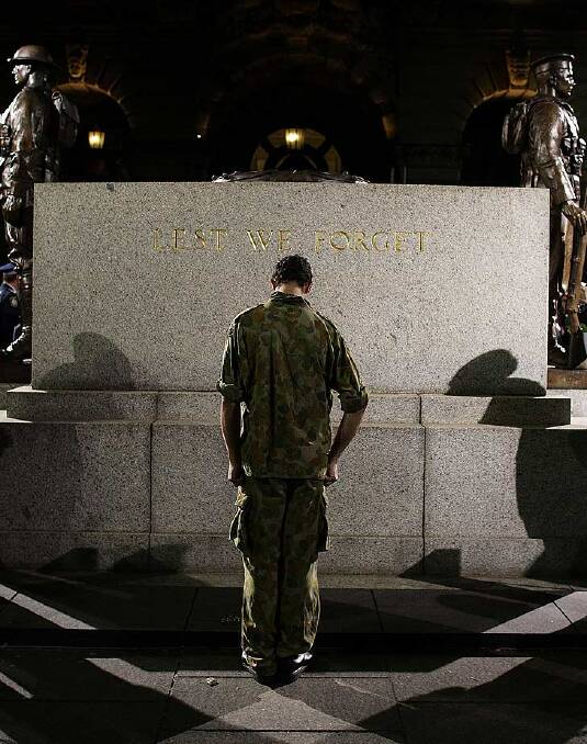 A serviceman pays tribute in front of the ANZAC Cenotaph at Martin Place in Sydney this morning. Photo: Getty