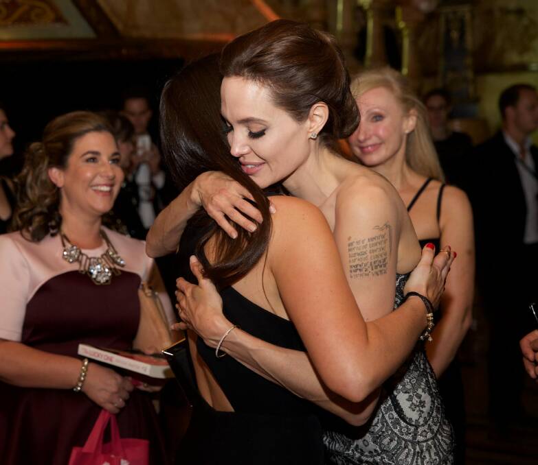 Angelina Jolie embraces Pink Hope founder Krystal Barter at the 'Unbroken' premiere in 2014.
