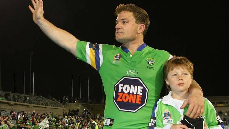 Simon Woolford of the Raiders farewells the Canberra crowd with his son Zac, in 2006. Photo: Getty Images