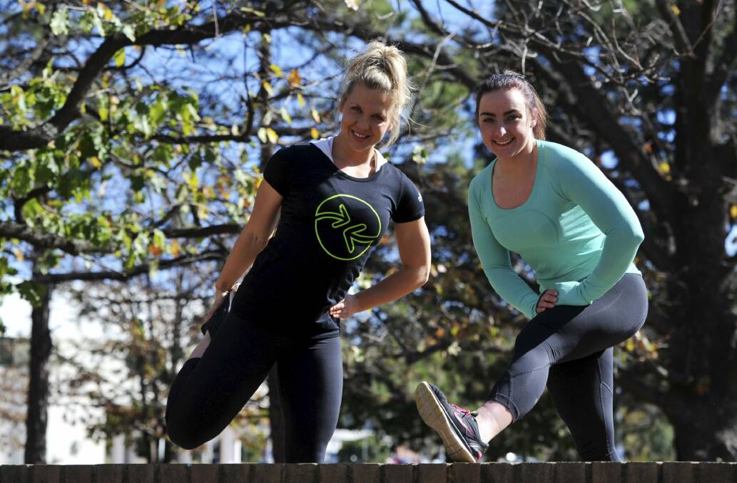 PRIORITIES: Co-organisers of the Wellness to Wholeness
Summit at the Belconnen Arts Centre, Myfanwy Galloway, right and
Harriet Walker, take some  exercise during a lunch
break. Photo: Graham
Tidy.