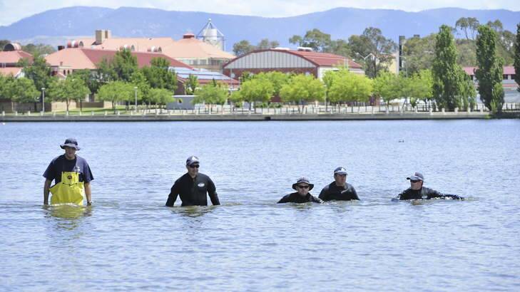 Police and SES search for missing windsurfer Bobby Dungca on Lake Tuggeranong earlier Tuesday. Photo: Melissa Adams