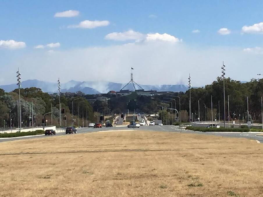 Smoke from a hazard reduction burns rises over Canberra. Photo: Scott Hannaford