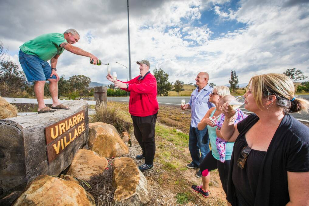 From left, Uriarra residents Aaron Agnew, Rod Sloan, Michael Friedrich, Janice Watt with Evie, 8, and Jess Agnew celebrate an announcement that a solar farm will not be build near their town. Photo: Matt Bedford