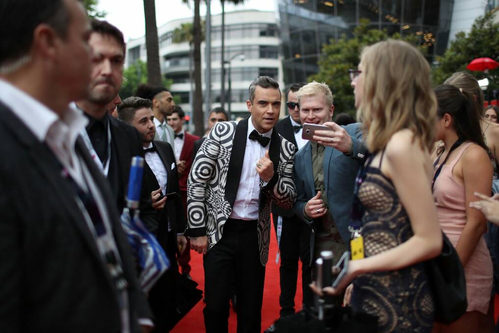 Canberra developer Bill O'Neill was captured by a press photographer getting his selfie with Robbie Williams at the ARIAs. Photo: Cameron Spencer